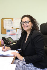 WILC Director Independent Living Team at her desk at WILC